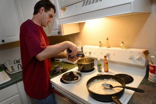 Scott Sommerdorf  |  The Salt Lake Tribune
Joseph Hardy makes dinner in his apartment, Friday, October 10, 2014.  Hardy has spent 14 years in jail and prison and has been an intravenous drug user. He's been clean for over a year and is in permanent assisted housing under Utah's Housing First program.