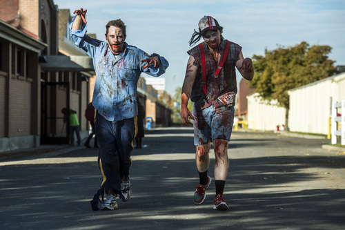 Chris Detrick  |  The Salt Lake Tribune
Zombies Tyler Lloyd, of South Jordan, and Cameron Romine, of Eagle Mountain, run during the Dawn of the Running Dead 5K race at the Utah State Fairpark Saturday October 18, 2014.