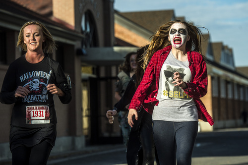 Chris Detrick  |  The Salt Lake Tribune
Zombie Emily Butler chases human Kristy Deans during the Dawn of the Running Dead 5K race at the Utah State Fairpark Saturday October 18, 2014.