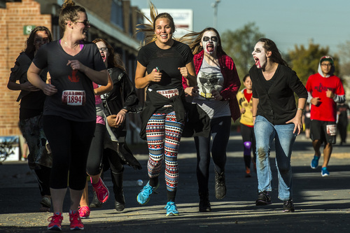Chris Detrick  |  The Salt Lake Tribune
Zombies Ruth Evans, Lucy Hill, Emily Butler and Faith Hilton chase down human runners during the Dawn of the Running Dead 5K race at the Utah State Fairpark Saturday October 18, 2014.