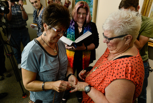 Francisco Kjolseth  |  The Salt Lake Tribune
Sheri Ault, left, and her partner of 18 years, Leslie McWilliams, are married by Reverend Heron (Tara Sudweeks Willgues) moments after getting their marriage license at the Salt Lake County Complex on Monday. The U.S. Supreme Court declined to review all five pending same-sex marriage cases on Monday, Oct. 6, 2014 effectively legalizing gay and lesbian unions, clearing the way for such marriages to proceed in 11 new states - including Utah.