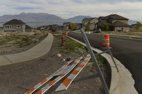 Leah Hogsten  |  The Salt Lake Tribune
Houses are built and work is continuing on sidewalks, streets and other facilities. But back in 2007 and 2008 under a different developer, purchasers couldn't get building permits because water facilities had not been completed. Many were foreclosed on.