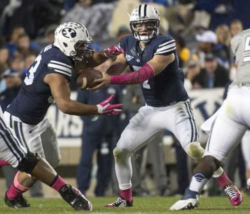 Rick Egan  |  The Salt Lake Tribune

Brigham Young Cougars running back Paul Lasike (33) takes a hand off from quarterback Christian Stewart (7)in football action, BYU vs The Nevada Wolf Pack at Lavell Edwards Stadium, Saturday, October18, 2014