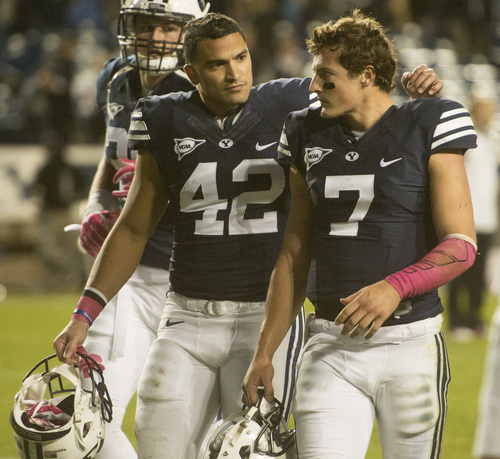 Rick Egan  |  The Salt Lake Tribune

Brigham Young Cougars linebacker Michael Alisa (42) comforts quarterback Christian Stewart (7) as they leave the field after losing to Nevada 42-35 at LaVell Edwards Stadium, Saturday, October18, 2014.