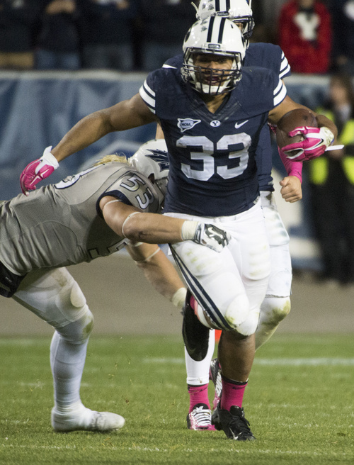 Rick Egan  |  The Salt Lake Tribune

Nevada Wolf Pack defensive end Brock Hekking (53) tries to stop Brigham Young Cougars running back Paul Lasike (33), in football action, BYU vs The Nevada Wolf Pack at LaVell Edwards Stadium, Saturday, October18, 2014