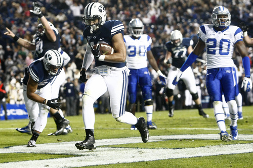 Chris Detrick  |  The Salt Lake Tribune
Brigham Young Cougars running back Michael Alisa (42) runs past Middle Tennessee Blue Raiders safety Kevin Byard (20) and Middle Tennessee Blue Raiders linebacker Stephen Roberts (30) for a touchdown during the first half of the game at LaVell Edwards Stadium Friday September 27, 2013. BYU is winning the game 23-10 at halftime.