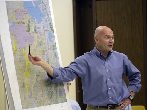 Al Hartmann  |  The Salt Lake Tribune
Lt. Col. Chris Robinson, a U.S. Air Force representative, discusses a map of expansion of the Utah Test and Training Range during a presentation at a public forum Monday Oct. 20, 2014, at West Desert High School in Partoun.