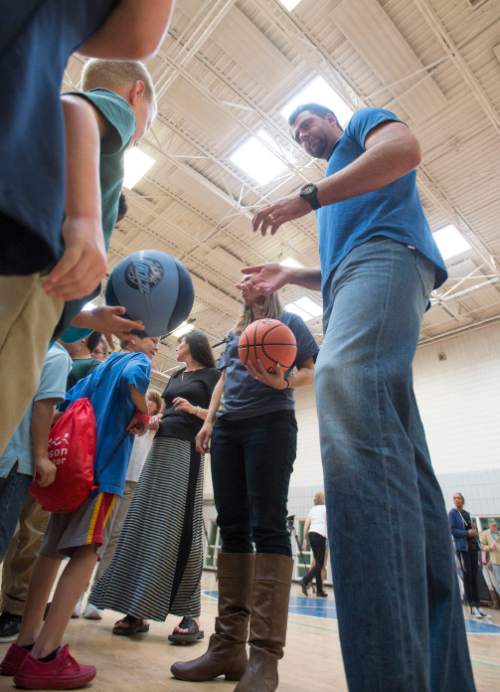 Steve Griffin  |  The Salt Lake Tribune


Turkish legend, former NBA All-Star and former Utah Jazz member, Mehmet Okur explains some basketball drills to children at the Sorenson Multicultural Center in Salt Lake City, Tuesday, October 14, 2014. Okur was at the center with current Utah Jazz player Enes Kanter who was giving youth in an after school program tickets which he personally purchased as part of his ongoing participation in the Jazz player ticket donation program.  Okur, a 2007 NBA All-Star, played for the Jazz from 2004-11 and recently joined the team as an ambassador to help with the organization's alumni program, community and fan relations efforts, basketball operations and business development.