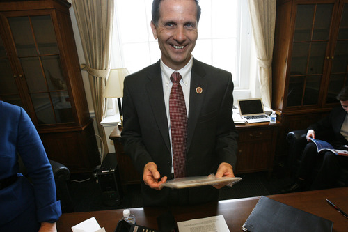 Scott Sommerdorf  |  Tribune file photo
Congressman-elect Chris Stewart, R-Utah, chuckles as he looks at his new congressional license plates on his desk Thursday, January 3, 2013.