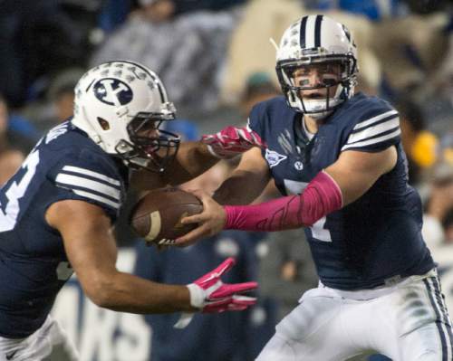 Rick Egan  |  The Salt Lake Tribune

Brigham Young Cougars running back Paul Lasike (33) takes a hand off from quarterback Christian Stewart (7)in football action, BYU vs The Nevada Wolf Pack at Lavell Edwards Stadium, Saturday, October18, 2014