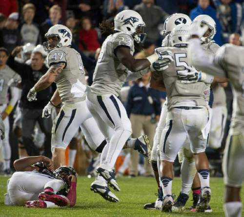 Rick Egan  |  The Salt Lake Tribune

Brigham Young Cougars quarterback Christian Stewart (7) lies on the ground as Nevada Wolf Pack celebrates after recovering Stewarts fumble with 39 seconds left in the game, and Nevada up 42-35, in football action, BYU vs The Nevada Wolf Pack at Lavell Edwards Stadium, Saturday, October18, 2014