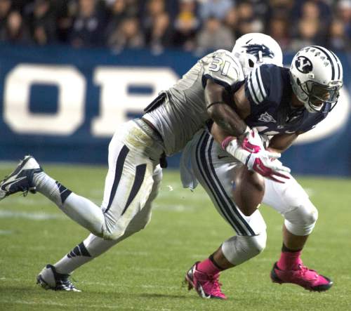 Rick Egan  |  The Salt Lake Tribune

Nevada Wolf Pack defensive back Randy Uzoma (31) strips the ball from Brigham Young Cougars wide receiver Terenn Houk (11), which Nevada recovered, in football action, BYU vs The Nevada Wolf Pack at Lavell Edwards Stadium, Saturday, October18, 2014