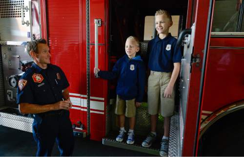 Francisco Kjolseth  |  The Salt Lake Tribune
Unified Fire Authority recognizes 10-year old Max Moffat, right, for his quick action in rescuing his 5-year old brother Miles alongside him, from a potential near drowning incident this summer. The event took place on July 18 at the Fox Point Old Farm Apartment Complex when Max was able to locate and bring Miles to the surface after the 5-year old slipped under water at a swimming party.