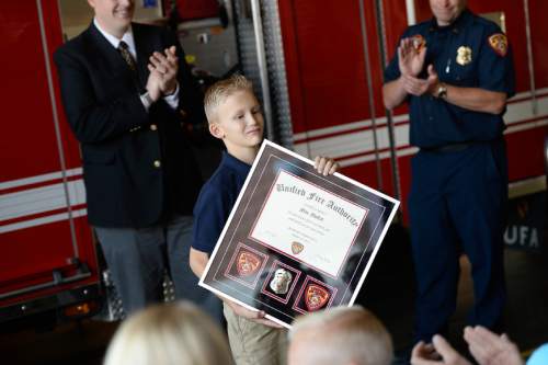 Francisco Kjolseth  |  The Salt Lake Tribune
Unified Fire Authority recognizes 10-year old Max Moffat for his quick action in rescuing his 5-year old brother Miles from a potential near drowning incident this summer. The event took place on July 18 at the Fox Point Old Farm Apartment Complex when Max was able to locate and bring Miles to the surface after the 5-year old slipped under water at a swimming party.