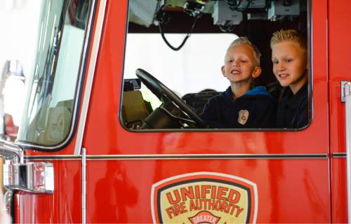 Francisco Kjolseth  |  The Salt Lake Tribune
Unified Fire Authority recognizes 10-year old Max Moffat, right, for his quick action in rescuing his 5-year old brother Miles, sitting next to him, from a potential near drowning incident this summer. The event took place on July 18 at the Fox Point Old Farm Apartment Complex when Max was able to locate and bring Miles to the surface after the 5-year old slipped under water at a swimming party.