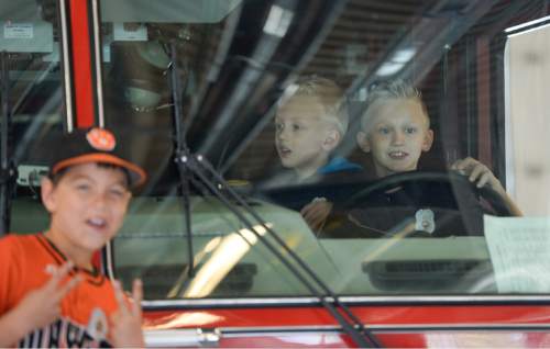 Francisco Kjolseth  |  The Salt Lake Tribune
Unified Fire Authority recognizes 10-year old Max Moffat, right, for his quick action in rescuing his 5-year old brother Miles, sitting next to him, from a potential near drowning incident this summer. The event took place on July 18 at the Fox Point Old Farm Apartment Complex when Max was able to locate and bring Miles to the surface after the 5-year old slipped under water at a swimming party.