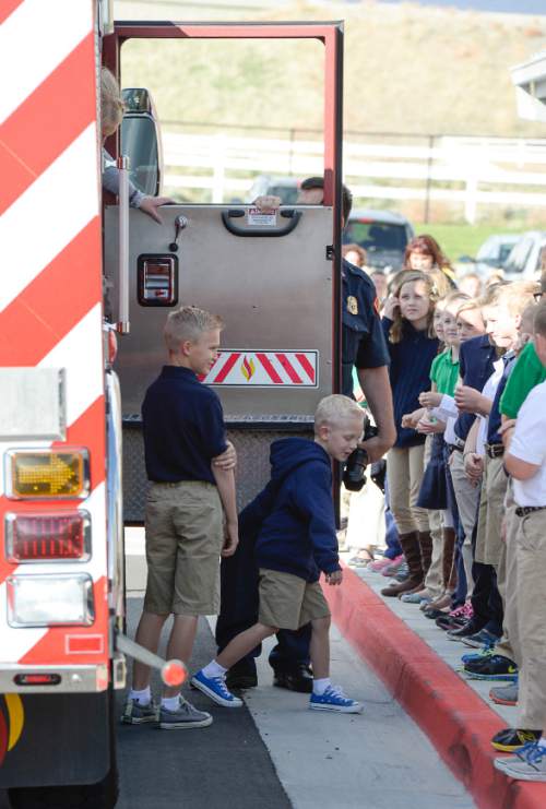 Francisco Kjolseth  |  The Salt Lake Tribune
Unified Fire Authority recognizes 10-year old Max Moffat , left, for his quick action in rescuing his 5-year old brother Miles from a potential near drowning incident this summer as he arrives at his school in West Jordan following a fire engine ride. The event took place on July 18 at the Fox Point Old Farm Apartment Complex when Max was able to locate and bring Miles to the surface after the 5-year old slipped under water at a swimming party.