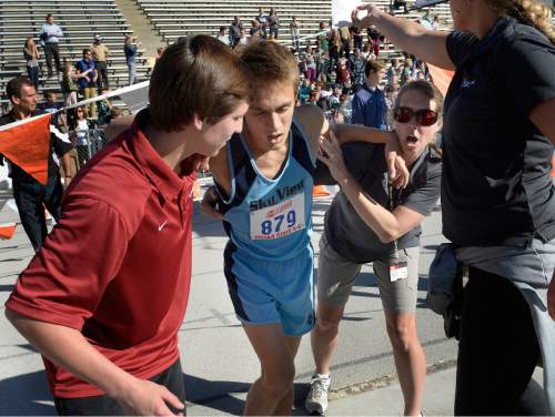 Scott Sommerdorf  |  The Salt Lake Tribune
An exhausted Conner Mantz is helped from the finish area after he collapsed just 20 meters from the finish line in the boys' 4A race at the Utah State cross-country races held at Sugar House Park and Highland H.S., Wednesday, October 22, 2014.