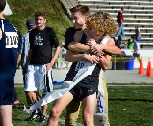 Scott Sommerdorf  |  The Salt Lake Tribune
Josh Collins of Wasatch High gets a hug from a buddy after winning the boys' 4A race ahead of defending champion Conner Mantz of Sky View, at the Utah State cross-country races held at Sugar House Park and Highland H.S., Wednesday, October 22, 2014.