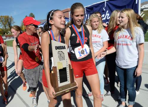 Scott Sommerdorf  |  The Salt Lake Tribune
Sammy Hollingsworth of American Fork holds the state 5A championship trophy after they upset favorite Davis High at the Utah State cross-country races held at Sugar House Park and Highland H.S., Wednesday, October 22, 2014.