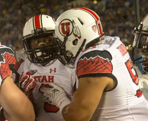 Rick Egan  |  The Salt Lake Tribune

 Ute defensive back Tevin Carter (9) is congratulated by defensive end Jason Fanaika (51) after he intercepted a UCLA pass for a touchdown, as the Utah Utes  vs. UCLA Bruins, at the Rose Bowl in Pasadena, Saturday, October 4, 2014