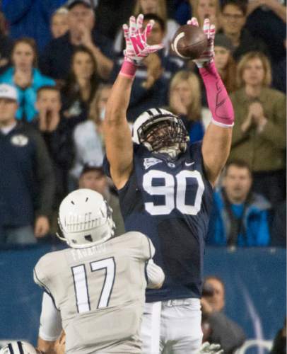 Rick Egan  |  The Salt Lake Tribune

Brigham Young Cougars linebacker DJ Doman (50) knocks down a pass by Nevada Wolf Pack quarterback Cody Fajardo (17) on a 3rd down play, in football action, BYU vs The Nevada Wolf Pack at Lavell Edwards Stadium, Saturday, October18, 2014