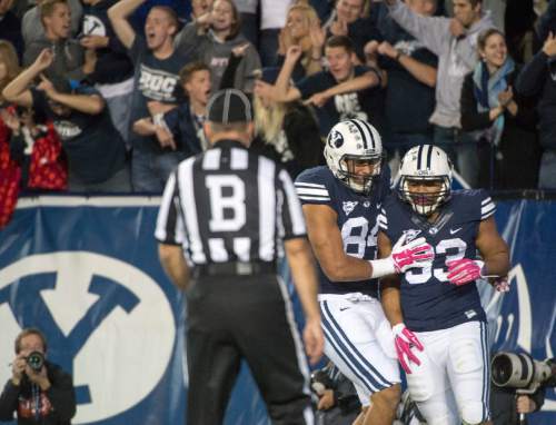 Rick Egan  |  The Salt Lake Tribune

Brigham Young Cougar fans cheer as   tight end Devin Mahina (84) celebrates the second touchdown by running back Paul Lasike (33), in football action, BYU vs The Nevada Wolf Pack at Lavell Edwards Stadium, Saturday, October18, 2014