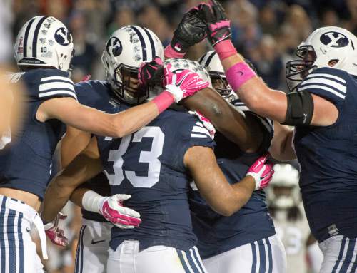 Rick Egan  |  The Salt Lake Tribune

Brigham Young Cougars celebrate the touchdown by running back Paul Lasike (33), in football action, BYU vs The Nevada Wolf Pack at Lavell Edwards Stadium, Saturday, October18, 2014