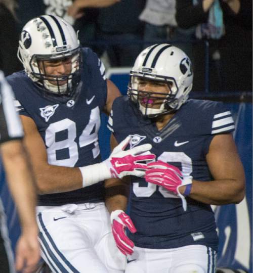 Rick Egan  |  The Salt Lake Tribune

Brigham Young Cougar tight end Devin Mahina (84) celebrates the second touchdown by running back Paul Lasike (33), in football action, BYU vs The Nevada Wolf Pack at Lavell Edwards Stadium, Saturday, October18, 2014