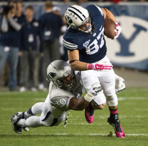 Rick Egan  |  The Salt Lake Tribune

Brigham Young Cougars wide receiver Mitchell Juergens (87) drags  Nevada Wolf Pack defensive back as he runs with teh ball, in football action, BYU vs The Nevada Wolf Pack at Lavell Edwards Stadium, Saturday, October18, 2014