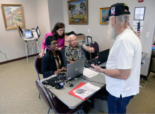 Al Hartmann  |  Tribune file photo
Poll workers check in Army veteran Dail Sullivan at the River Bend Senior Center in Salt Lake City in October, with the start of early voting. Despite early voting, by-mail voting and same-day registration reforms, Utah continues to have among the lowest voter turnout rates in the nation.