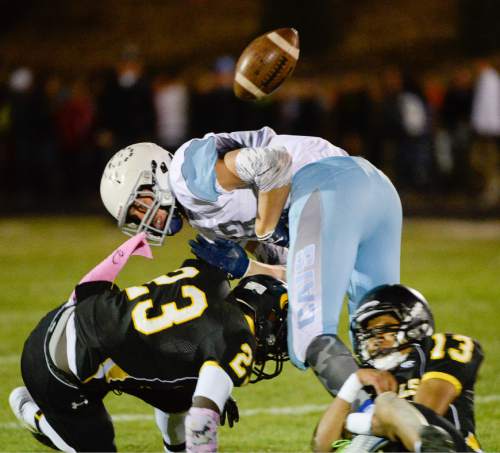 Francisco Kjolseth  |  The Salt Lake Tribune
Sky View's Bryce Mortenson, #13, has the ball knocked away as Roy defenders Nate Jones, #23, and Carlos Guerrero, #13, apply the pressure in game action on Thursday, Oct. 23, 2014, at Roy High School.
