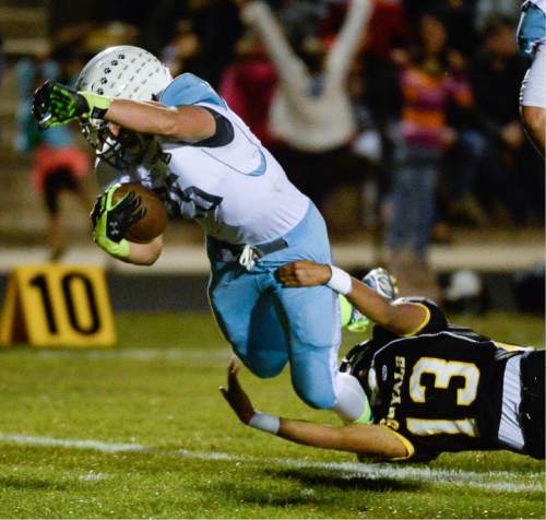 Francisco Kjolseth  |  The Salt Lake Tribune
Sky View's Isaac Herrmann, #25, is taken down by Carlos Guerrero, #13, of Roy in game action on Thursday, Oct. 23, 2014, at Roy High School.