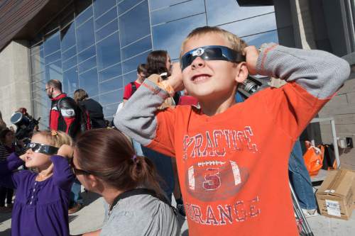 Trent Nelson  |  The Salt Lake Tribune
Mia and Ian Travis look up at a partial solar eclipse, with their mother Susanna at the Natural History Museum of Utah in Salt Lake City, Thursday October 23, 2014.