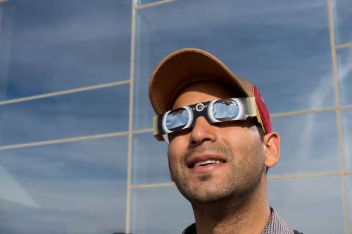 Trent Nelson  |  The Salt Lake Tribune
Eli Weffer looks up at a partial solar eclipse, at the Natural History Museum of Utah in Salt Lake City, Thursday October 23, 2014.