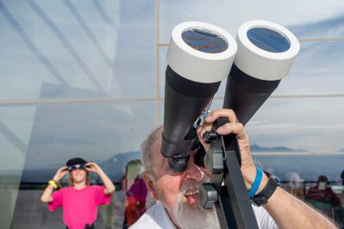 Trent Nelson  |  The Salt Lake Tribune
Larry Holmes points his filtered binoculars at a partial solar eclipse at the Natural History Museum of Utah in Salt Lake City, Thursday October 23, 2014.