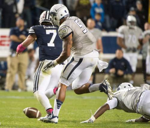 Rick Egan  |  The Salt Lake Tribune

Brigham Young Cougars quarterback Christian Stewart (7) trees to recovered that ball after his fumble with less than a minute in the game, in football action, BYU vs The Nevada Wolf Pack at Lavell Edwards Stadium, Saturday, October18, 2014