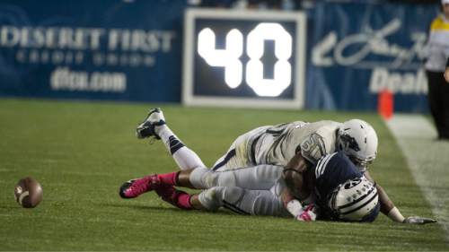 Rick Egan  |  The Salt Lake Tribune

Nevada Wolf Pack defensive back Randy Uzoma (31) strips the ball from Brigham Young Cougars wide receiver Terenn Houk (11), which Nevada recovered, in football action, BYU vs The Nevada Wolf Pack at Lavell Edwards Stadium, Saturday, October18, 2014