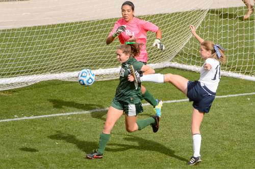 Trent Nelson  |  The Salt Lake Tribune
Rowland Hall defender Kaela Gilbert (26) prevents a goal by Waterford's Madeline Duke (10) as Rowland Hall defeats Waterford in the 2A girls' high school soccer state championship game at Rio Tinto Stadium in Sandy, Saturday October 25, 2014. Rowland Hall goalkeeper Alyssa Cole (21) at rear.