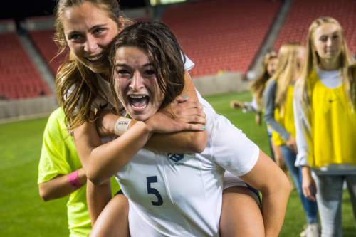 Chris Detrick  |  The Salt Lake Tribune
Timpanogos' Olivia Burnett (16) celebrates with Timpanogos' Natalie Reynolds (5) after winning during the 4A girls' state soccer championship game at Rio Tinto Stadium Friday October 24, 2014. Timpanogos defeated Skyline 7-6 in an overtime shootout.
