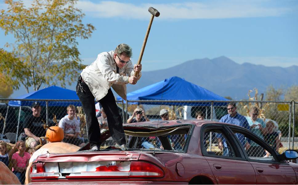 Scott Sommerdorf  |  The Salt Lake Tribune
Dennis Shurtleff takes a sledge hammer to an old car after making a charitable donation at Hee Haw Farms in Pleasant Grove, Saturday, October 25, 2014. Hee Haw Farms and the Giant Pumpkin Growers have teamed up with the March of Dimes for the 6th Annual Giant Pumpkin Drop. in Pleasant Grove, Saturday, October 25, 2014.
