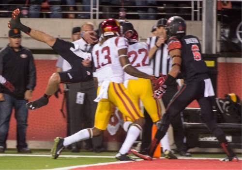Rick Egan  |  The Salt Lake Tribune
 
Utah quarterback Travis Wilson (7) dives into the end zone in the Utes' 24-21 victory over the USC Trojans at Rice-Eccles Stadium, Saturday, October 25, 2014. The touchdown call was overturned on review and Utah got the ball on the 1 yard line