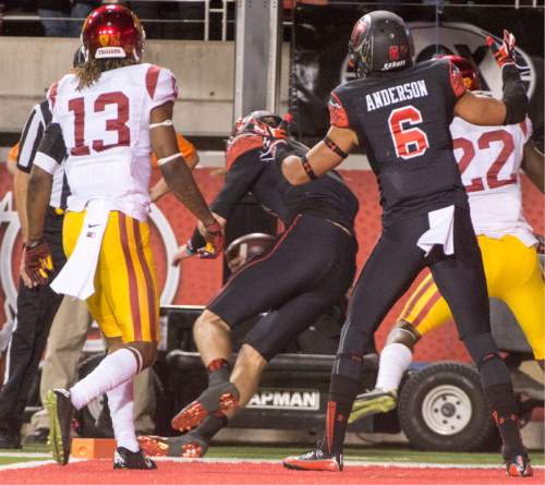 Rick Egan  |  The Salt Lake Tribune
 
Utah quarterback Travis Wilson (7) lands out of bounds as he dives into the end zone in the Utes' 24-21 victory over the USC Trojans at Rice-Eccles Stadium, Saturday, October 25, 2014. The touchdown call was overturned on review and Utah got the ball on the 1 yard line