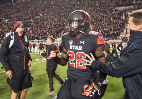 Rick Egan  |  The Salt Lake Tribune
Ute fans storm the field with running back Tavaris Williams (26) as they celebrate Utah's 24-21 victory over the USC Trojans at Rice-Eccles Stadium, Saturday, October 25, 2014.