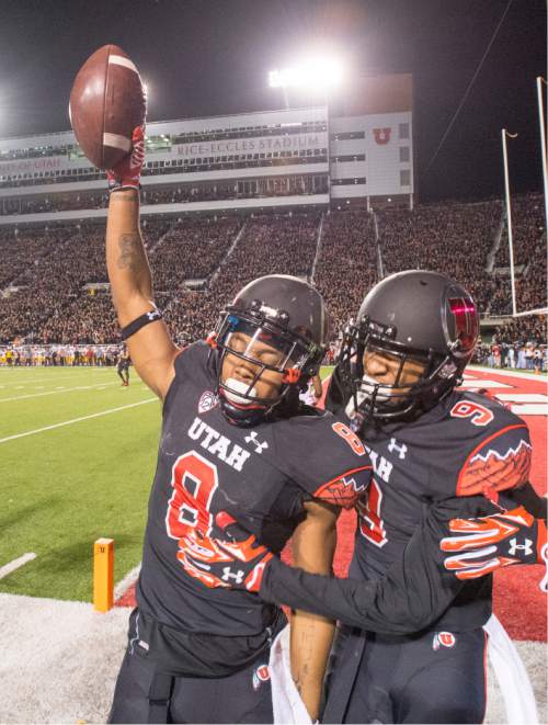 Rick Egan  |  The Salt Lake Tribune
 
Utah Utes wide receiver Kaelin Clay (8) celebrates with wide receiver Tim Patrick (9) after scoring the game-winning touchdown, with 8 seconds left in the game, giving the Utes a 24-21 victory of the USC Trojans in Pac-12 action at Rice-Eccles Stadium, Saturday, October 25, 2014.