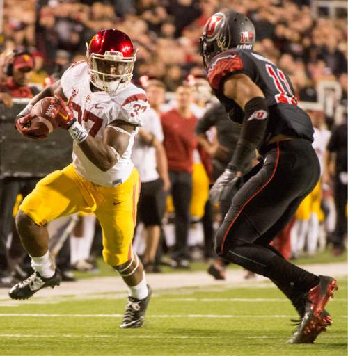 Rick Egan  |  The Salt Lake Tribune
 
USC Trojans running back Javorius Allen (37) tries to get past Utah Utes defensive back Davion Orphey (11) in the Utes a 24-21 victory over the USC Trojans, at Rice-Eccles Stadium, Saturday, October 25, 2014. The touchdown call was overturned on review, the Utes got the ball on the 1-yard line