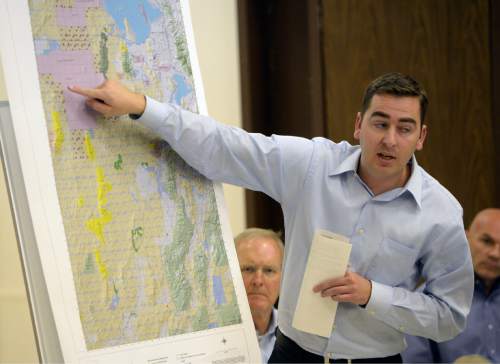 Al Hartmann  |  The Salt Lake Tribune
Ed Cox a representative from Senator Orrin Hatch's office discusses map of expansion of the Utah Test and Training Range during a presentation at a public forum Monday October 20 at West Desert High School in Partoun.