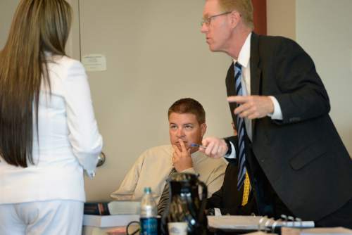 Scott Sommerdorf  |  The Salt Lake Tribune
Former West Valley City police officer Shaun Cowley, center, looks on as attorneys Lindsay Jarvis, left, and Paul Cassell confer just prior to the afternoon session of day three of Cowley's preliminary hearing, Wednesday, October 8, 2014. Cowley is charged with second-degree felony manslaughter for Nov. 2, 2012, fatal shooting of 21-year-old Danielle Willard.