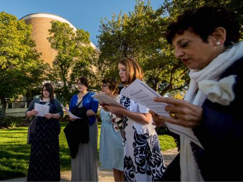 Trent Nelson  |  The Salt Lake Tribune
A group of people sing an LDS hymn before entering a broadcast of the LDS General Priesthood Session at BYU's Marriott Center in Provo Saturday October 4, 2014. The event was one of several planned by Ordain Women.