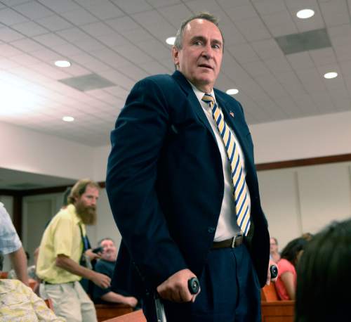 Al Hartmann  |  The Salt Lake Tribune 
Former attorney general Mark Shurtleff using crutches looks for a place to sit in Judge Royal Hansen's courtroom in Salt Lake City Wednesday July 30.   Shurtleff and former attorney general John Swallow are charged with receiving or soliciting bribes, accepting gifts, tampering with evidence, obstructing justice and participating in a pattern of unlawful conduct.